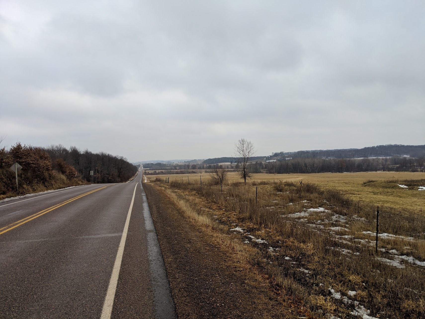 Empty road in the midwest, atop a hill during extreme overcast weather.